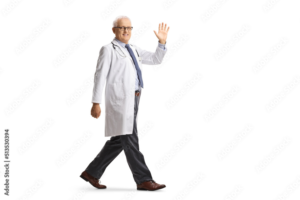 Full length shot of a mature male doctor walking and waving Full length shot of a mature male doctor walking and waving
