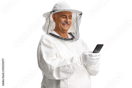 Mature male bee keeper in a uniform using a smartphone