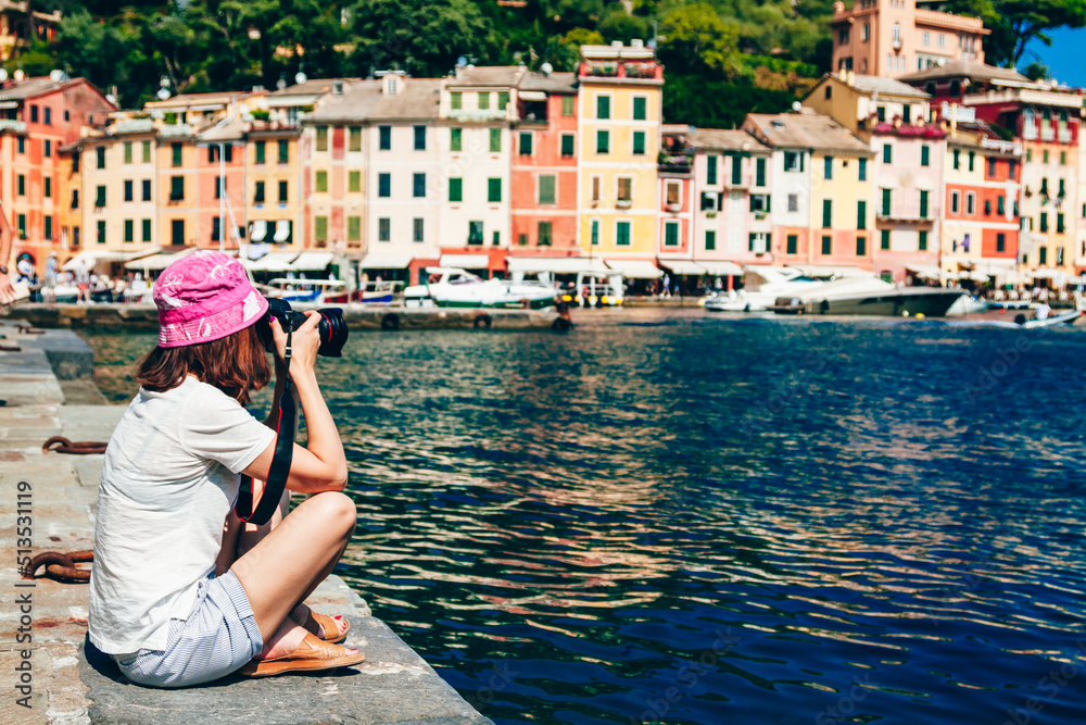 Young girl taking picture in old famous town in Italy