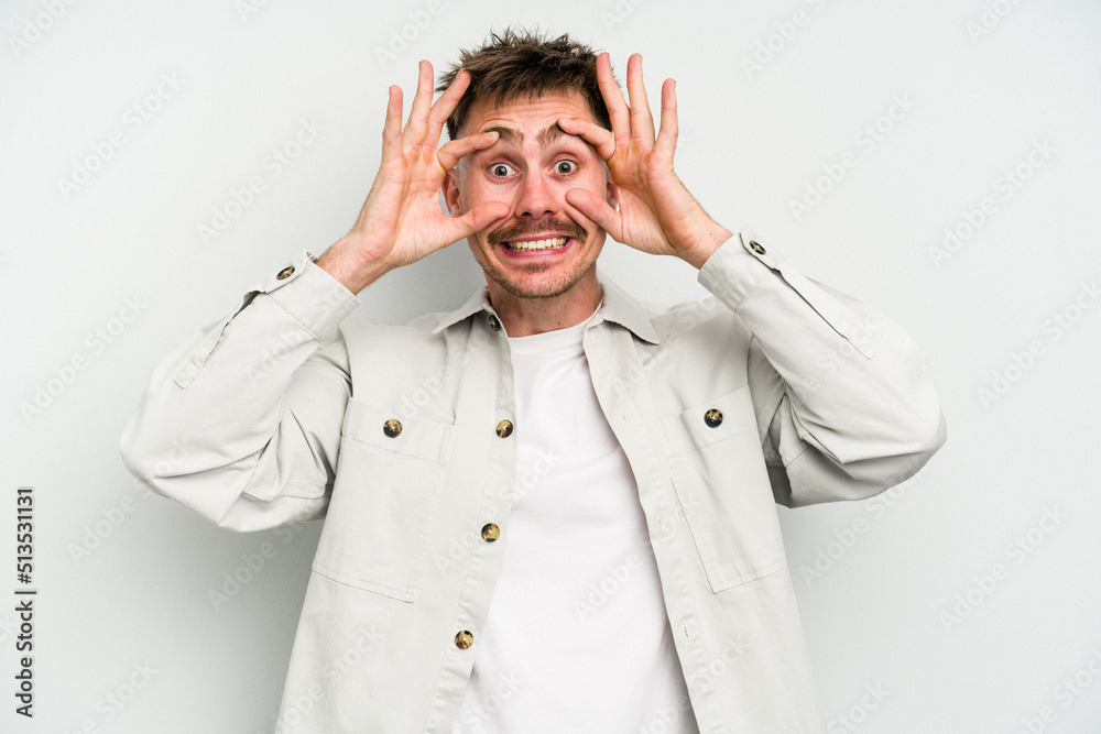Young caucasian man isolated on white background keeping eyes opened to find a success opportunity.