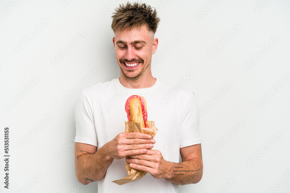 Young caucasian man holding a sandwich isolated on white background Young caucasian man holding a sandwich isolated on white background