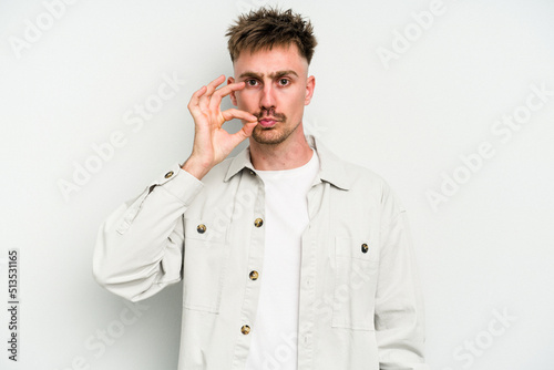 Young caucasian man isolated on white background with fingers on lips keeping a secret.