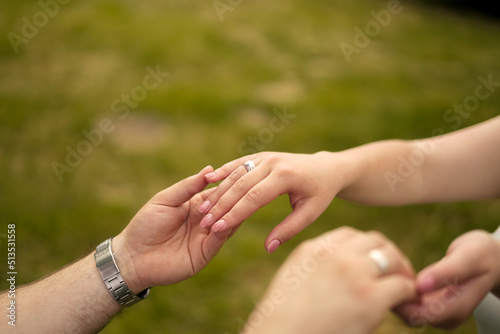 bride and groom hold hands. Large frame. You can see the wedding rings © Дмитрий Дементьев