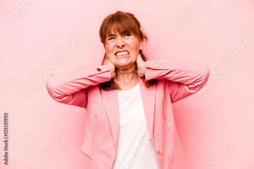 Middle age caucasian woman isolated on pink background suffering neck pain due to sedentary lifestyle.