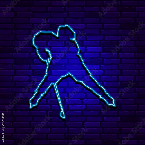 Neon silhouette of a hockey player in defensive position on dark blue brick wall background