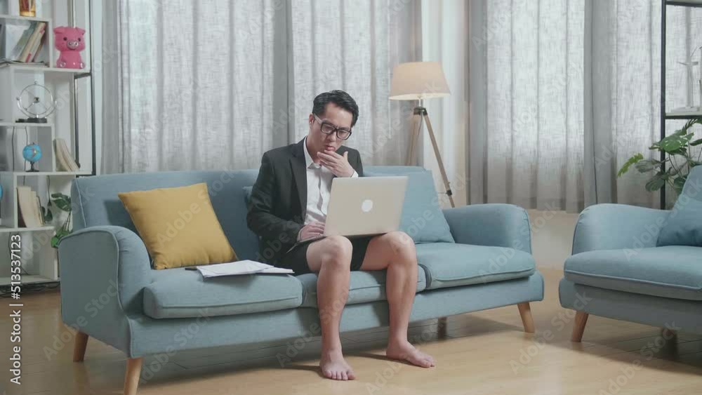 Full View Of Asian Businessman In Jacket And Shorts Being Tired While Working With A Laptop At Home
Full View Of Asian Businessman In Jacket And Shorts Being Tired While Working With A Laptop At Home