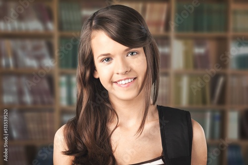 Attractive teenage girl pose in library. Higher education institution student, excellent studies concept