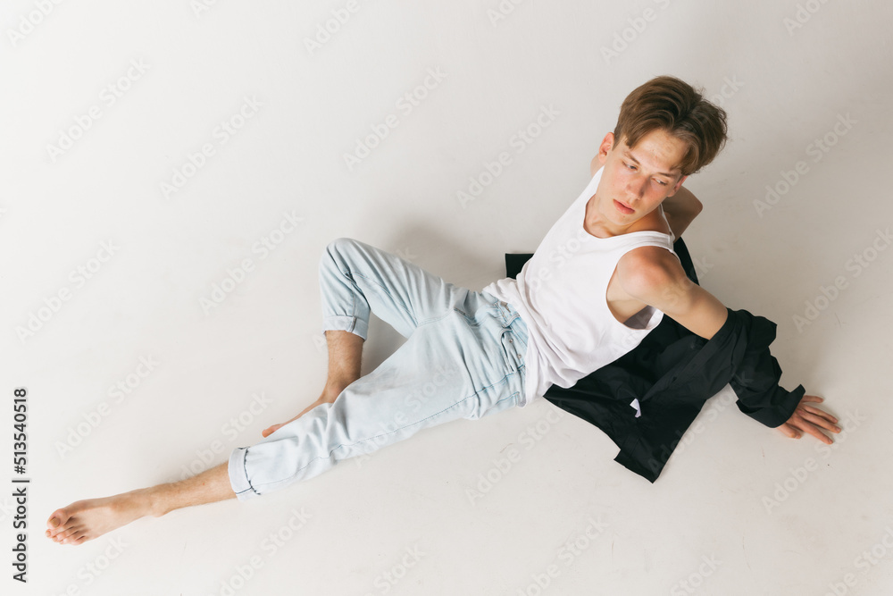 Obraz premium Portrait of young man, teen, student posing isolated over white studio background. Concept of fashion, youth, emotions, facial expression, ad