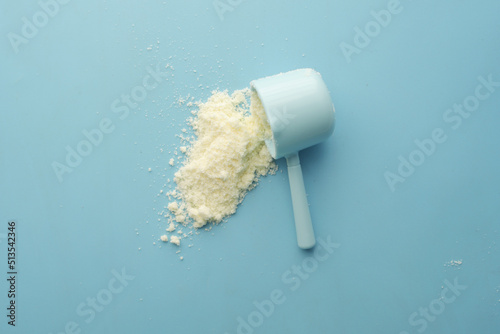 Tableau sur toile Close up of baby milk powder and spoon on tile background.