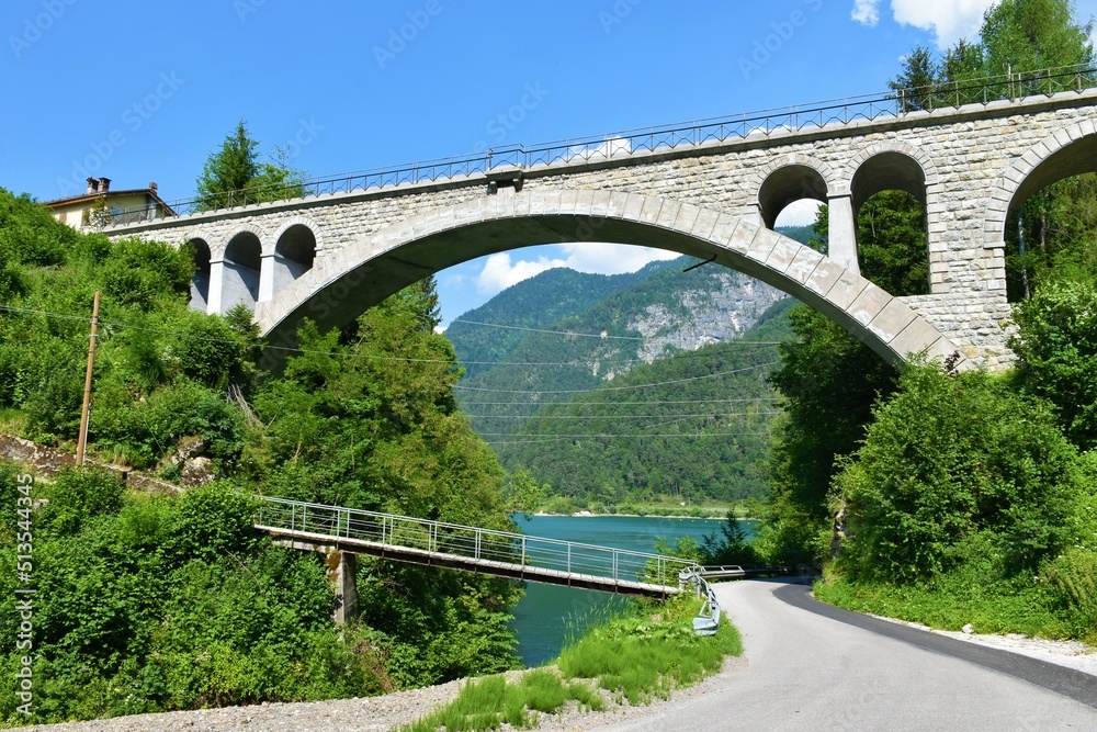 Railway bridge at Lago di Cadore lake near Pieve di Cadore in Veneto region and Belluno province in Italy