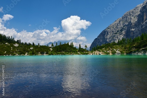 Scenic view of lake Sorapis in turquoise and blue colors and clouds covering the mountain behind near Cortina d'Ampezzo in Veneto region and Belluno province in Italy