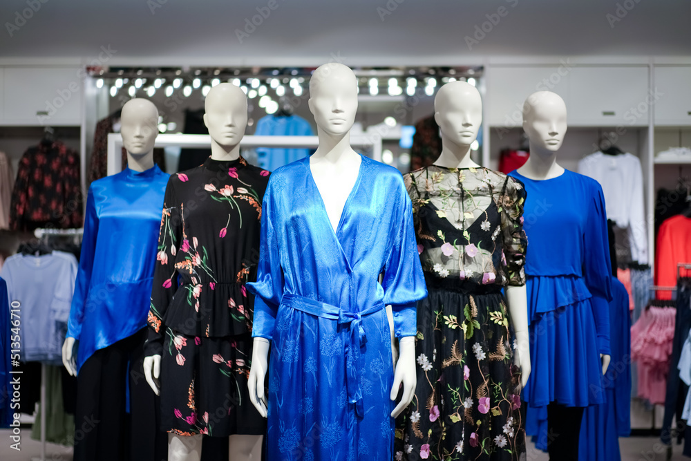 Female mannequins are dressed in casual clothes with a red-orange theme in fashion shop at the department store. Female mannequins are dressed in casual clothes with a red-orange theme in fashion shop at the department store.