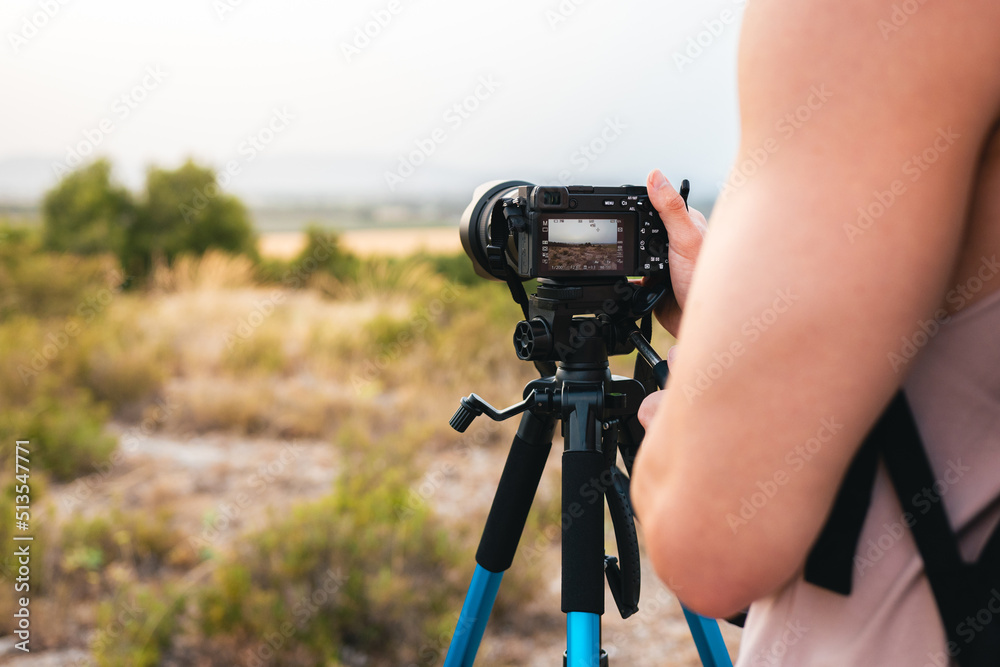 Close-up of a man taking pictures with his camera outdoors
