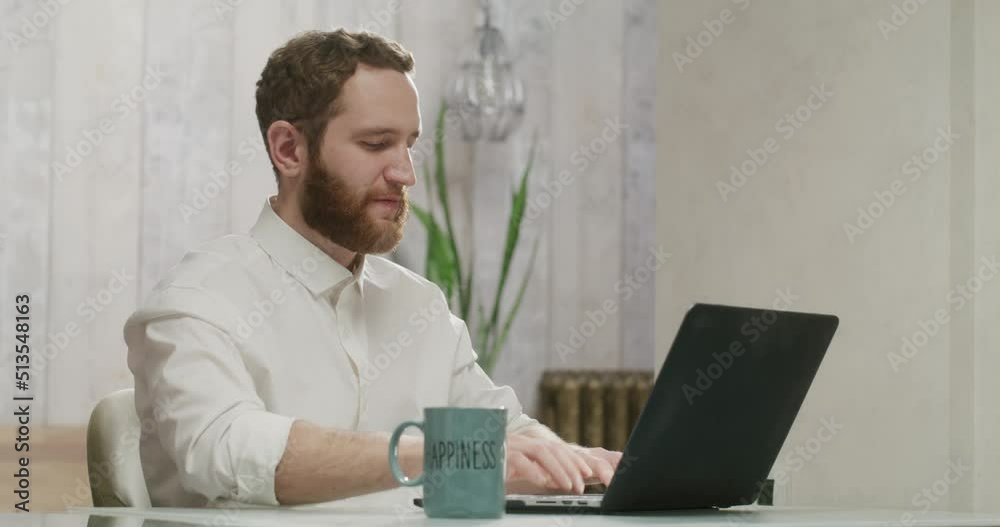 happy man working at his computer at home happy man working at his computer at home