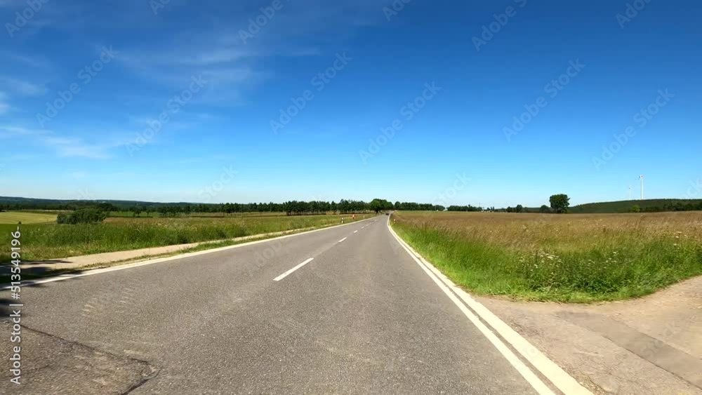 POV Driving on motorcycle on a scenic road in Eifel National Park in Germany through hills and forest POV Driving on motorcycle on a scenic road in Eifel National Park in Germany through hills and forest