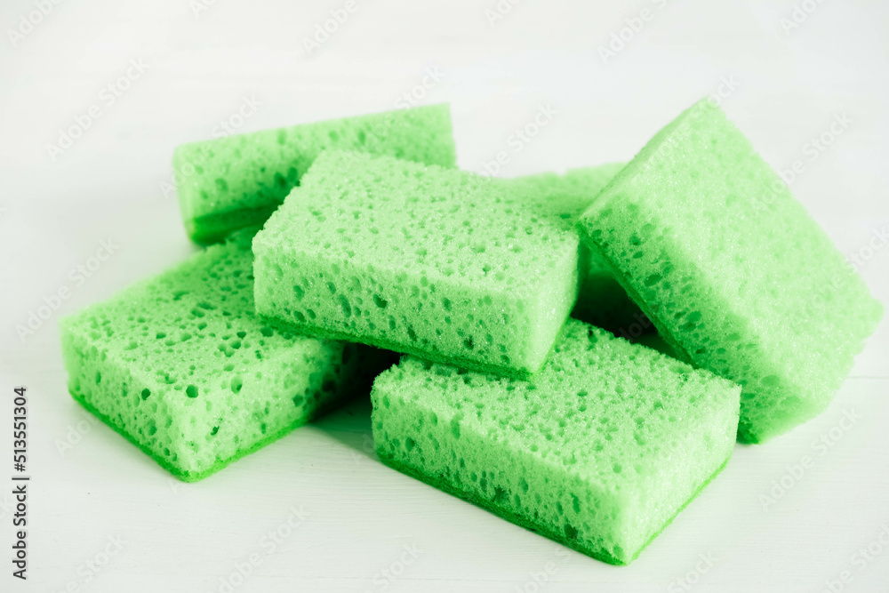 Green sponges for cleaning on a white background Green sponges for cleaning on a white background