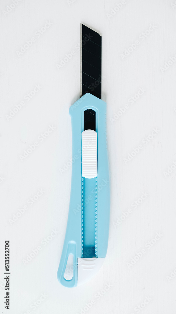 Stationery knife in blue on a white background Stationery knife in blue on a white background