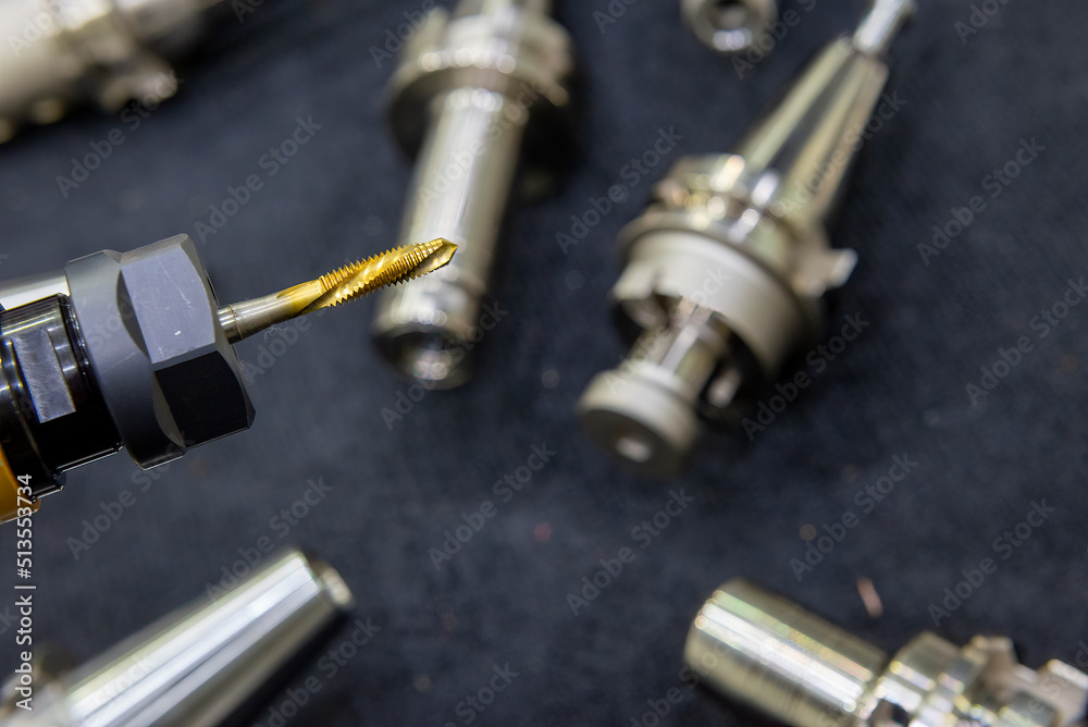 Close-up scene the used tapping tools for CNC milling machine. The thread cutting tool for machining center. Close-up scene the used tapping tools for CNC milling machine. The thread cutting tool for machining center.