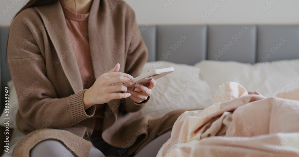 Woman use cellphone on bed