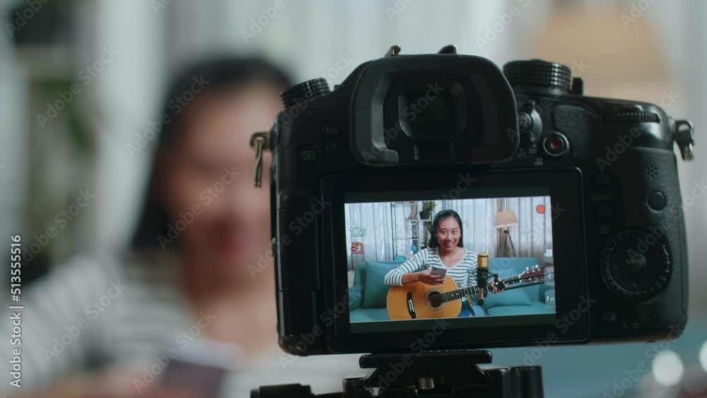 Close Up Of A Camera Monitor Recording Asian Woman Reading Comments On Smartphone And Speaking While Live Stream Playing Guitar At Home
Close Up Of A Camera Monitor Recording Asian Woman Reading Comments On Smartphone And Speaking While Live Stream Playing Guitar At Home