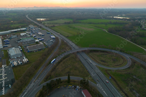 Aerial view of highway road intersection with fast moving heavy traffic. Intercity transportation with many cars and trucks © bilanol