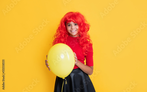 cheerful girl with party balloon on yellow background © be free