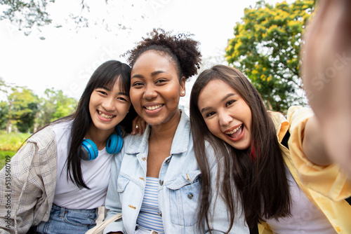 Diversity of students friends making selfie and showing bright smile, posing outdoors in campus at the park.Teens happy about entering university. Leisure and freedom in natural