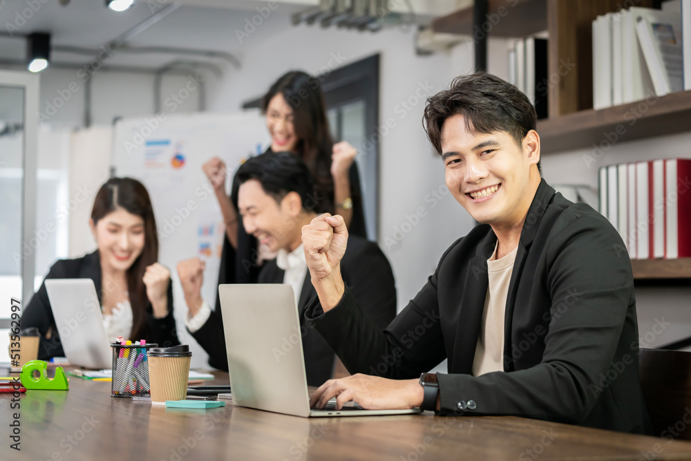 Asian businessman looking at the camera Working and meeting at the office at the company with colleagues at the back Asian businessman looking at the camera Working and meeting at the office at the company with colleagues at the back
