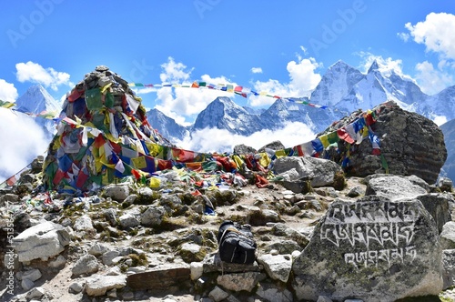 Beautiful view of Everest Base Camp in Khumjung, Nepal, with flags under the blue sky photo