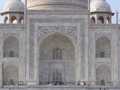 Taj Mahal, Agra, India, August 18, 2011: Facade with one of the entrances of the white marble mausoleum with four minarets and large domes. Taj Mahal