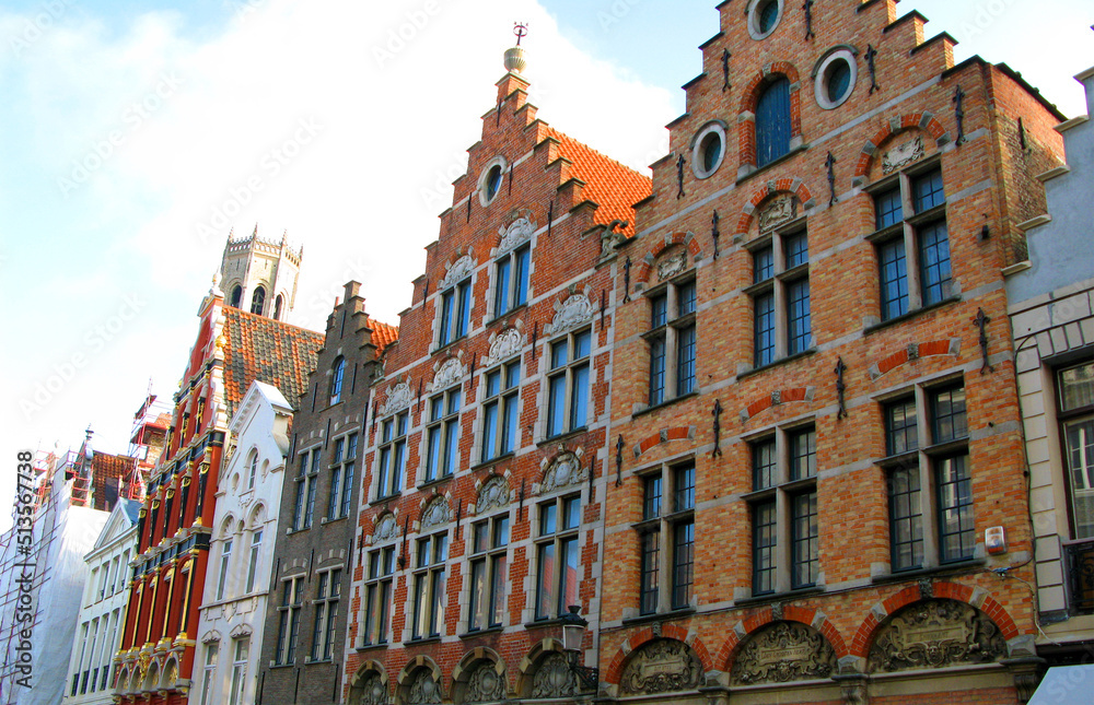 Bruges, Brugge, facades of ancient houses of an unusual shape against the blue sky, ancient architecture, Belgium