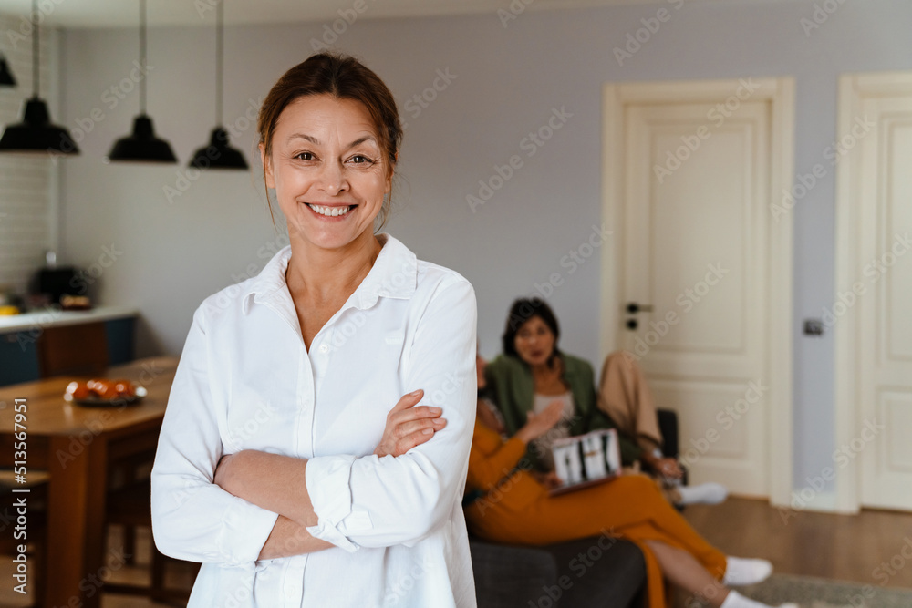 Fototapeta premium Mature woman smiling while spending time with her friends