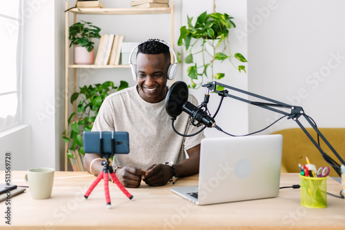 Fotografija Young adult african man streaming live video at home studio - Millennial content