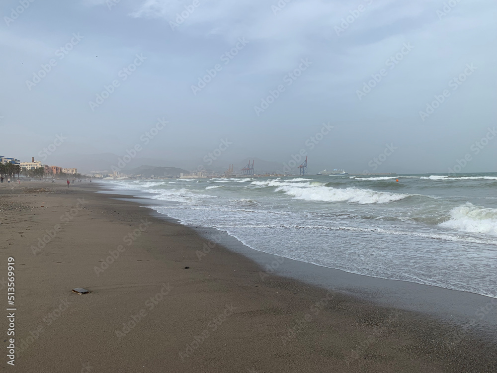 Restless sea on a cloudy day on the beach in Malaga