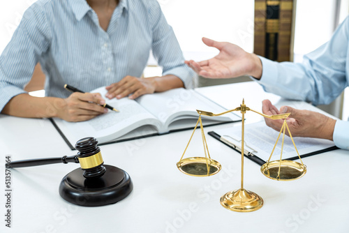 Male lawyer or notary consulting and discussion to businesswoman client in the office, Judge gavel with scales of justice © Freedomz