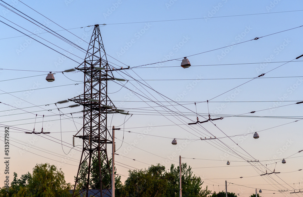 Group silhouette of transmission towers (power tower, electricity pylon, steel lattice tower) at twilight in US
