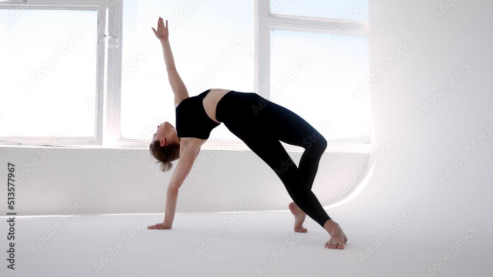 Young woman practicing yoga and doing exercises indoors. Relaxation , balance, healthy lifestyle, meditation, mindfulness, workout, fitness, self care, training concept