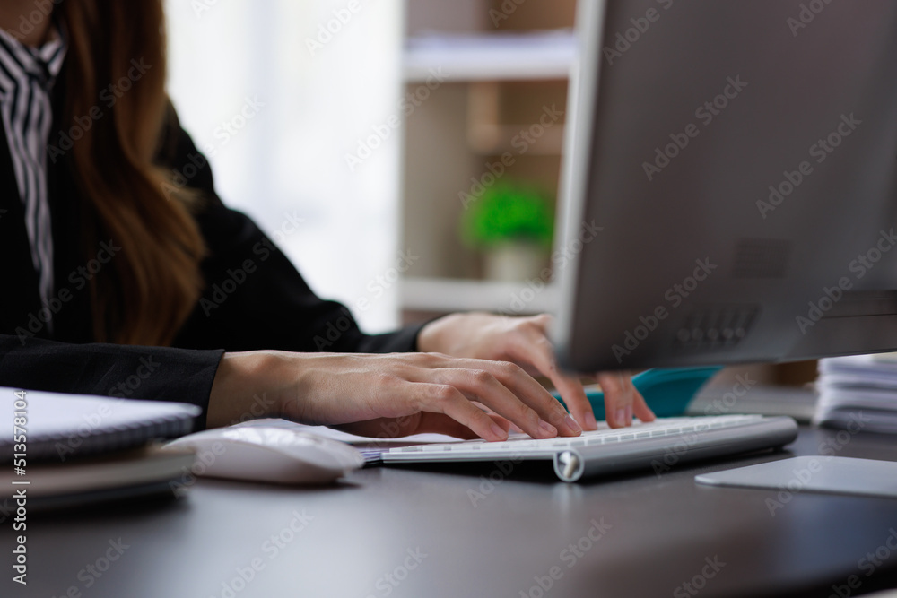Close up of Asian Woman working at home office hand on keyboard Close up of Asian Woman working at home office hand on keyboard