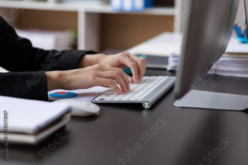 Close up of Asian Woman working at home office hand on keyboard 