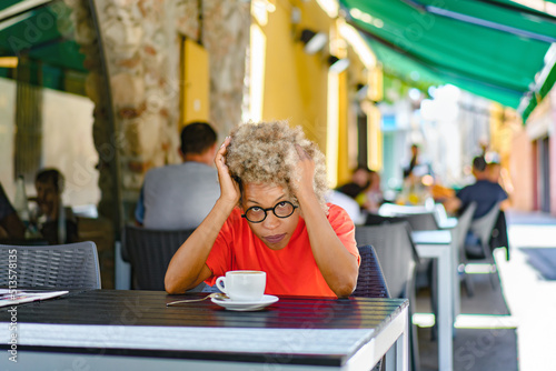 nervous woman looking out somebody while drinking coffee