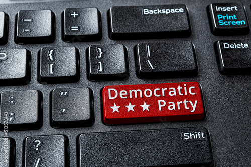 Democratic Party red key on a decktop computer keyboard. Concept of voting online for Democratic party, politics, United States elections. Laptop enter key with Democratic Party word message. photo