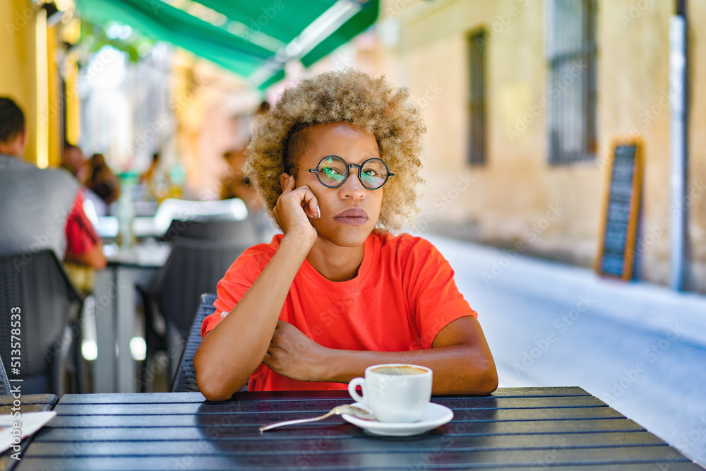 woman with cup drinking cafe at city street cafe terrace