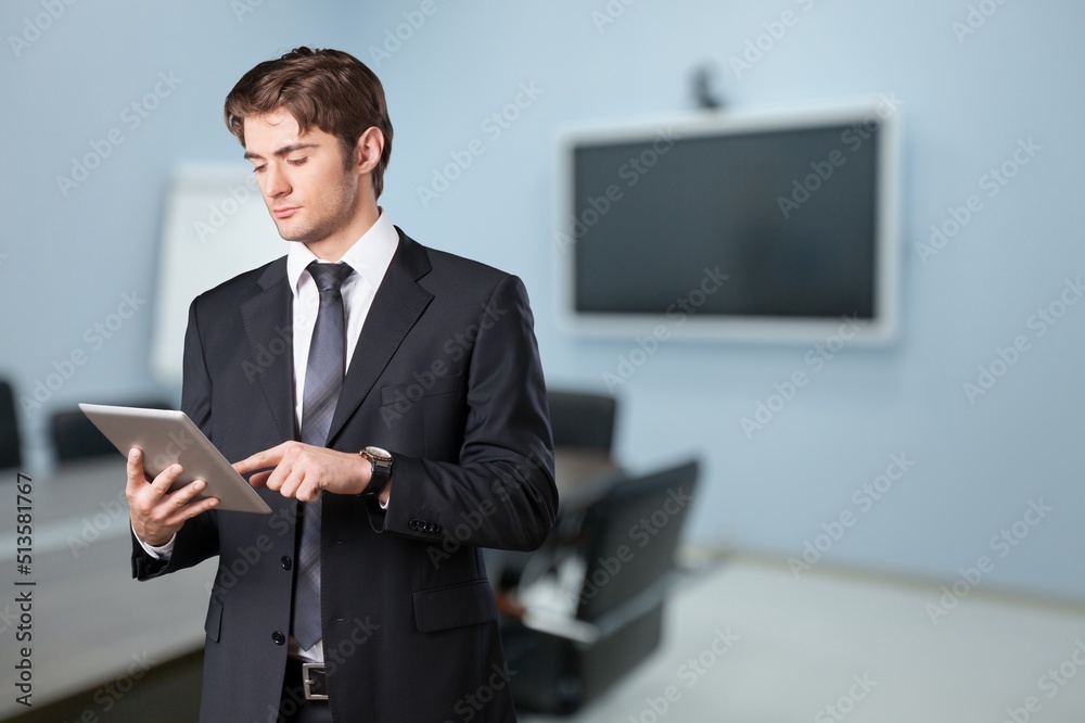 Portrait of young businessman using ldigital tablet Portrait of young businessman using ldigital tablet
