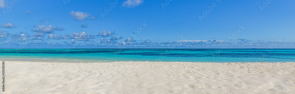 Fototapeta premium Closeup sand beach sea waves and blue summer sky. Panoramic beach landscape. Empty tropical beach and seascape, horizon. Bright exotic coast calmness, tranquil seaside nature view relaxing sunlight