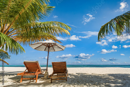 Amazing vacation beach. Chairs on the sandy beach near the sea. Summer romantic holiday tourism. Beautiful tropical island landscape. Tranquil shore scenery, relax sand seaside horizon, palm leaves © icemanphotos