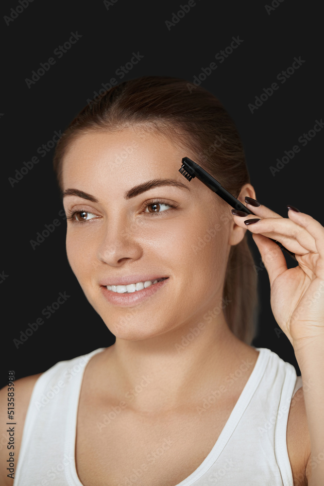 Beauty makeup. Eyebrows Care. Beautiful woman shaping brows with comb. Correcting and contouring eyebrows. Beauty makeup. Eyebrows Care. Beautiful woman shaping brows with comb. Correcting and contouring eyebrows.