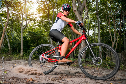 Mountain bikers ride MTB, mountain bike downhill to the extreme. Asian man rides MTB, mountain bike downhill in the wild to extremes. Extreme Sport and MTB, mountain bike downhill Concept.