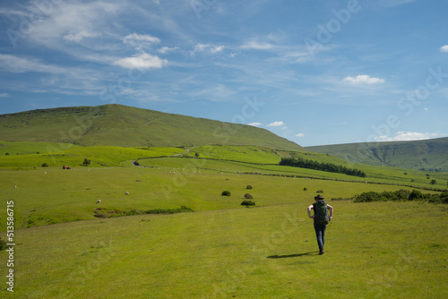 Hiker with backpack and hat walks on Offa's Dyke Path in Wales close to the Black Mountains © Haris Photography