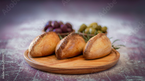 La salteña es un tipo de empanada de origen boliviano , ​ comido como una merienda jugosa y rellena con carne, pollo u otras carnes, huevo duro, especias, y otros ingredientes, cocida al horno