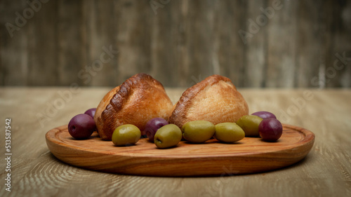 La salteña es un tipo de empanada de origen boliviano , ​ comido como una merienda jugosa y rellena con carne, pollo u otras carnes, huevo duro, especias, y otros ingredientes, cocida al horno